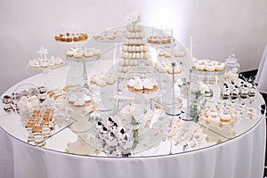 Cake bar on wedding. Differnt type of sweeties on the table. Eclair, cake pops, muffins and mamy others desserts