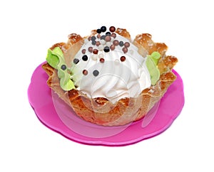Cake basket with white cream decorated with small balls