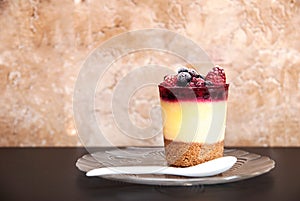 Cake with berries on a transparent plate
