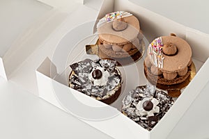 A cake box of delicate gourmet pastry cakes, against a light background.