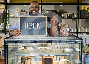 Cake cafe owners with open sign photo