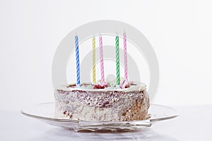 Cake with candles as symbol of birthday party and celebration. Holiday concept