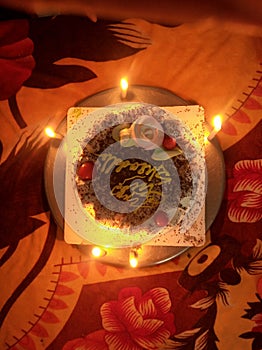 A Cake with candles in candle light