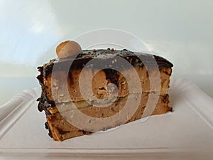 Cake with chocolate and cookie balls on white background