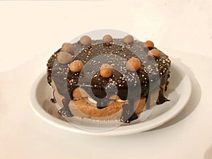 Cake with chocolate and cookie balls on white background