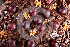 Cake with chocolate icing and grapes close up