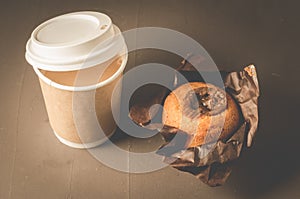 Cake with a chocolate stuffing and cappuccino plastic cup/cake with a chocolate stuffing and cappuccino plastic cup on a dark