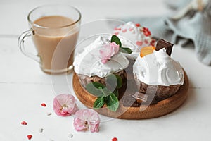 Cake and Coffee. Tasty cakes with cream and pink flower decor in wooding plate. Good morning. Perfect breakfast