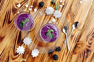 Cake with cream cheese and fresh blueberries in glass cup. Top horizontal view with copy spae for text.