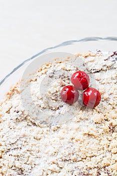 Cake with crumb and cherry, close-up