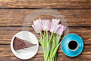 Cake and cup of coffee with tulips