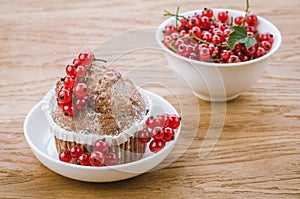 cake is decorated with berries and red currant in a white bowl/cake is decorated with berries and red currant in a white bowl on