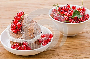 Cake is decorated with berries and red currant in a white bowl/cake is decorated with berries and red currant in a white bowl.