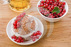 cake is decorated with berries and red currant in a white plate/cake is decorated with berries and red currant in a white plate.