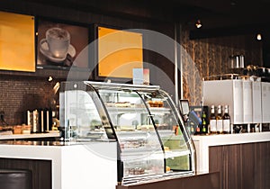 Cake Display Fridges on Deli or Coffee Shop. Restaurant Interior Concept. photo