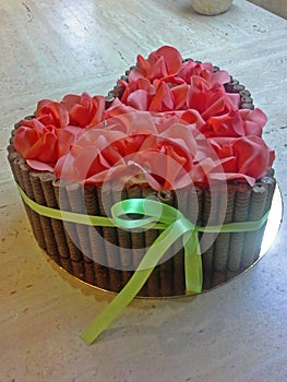 Cake in form of heart with red and pink sugar roses