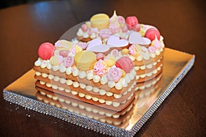A cake in the form of two figures. Number two Biscuit cake. Birthday cake with pink hearts, macaroni and bezye. Cake for a girl