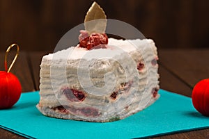 Cake with fresh cherry on wooden background