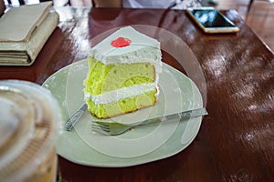 Cake and Ice coffee are on the wood table