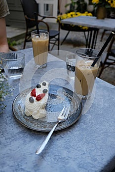 Cake and iced coffe in a cafe on a nice summer day