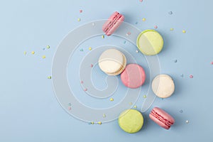 Cake macaron or macaroon on blue background, colorful almond cookies. French almond cookies on dessert.