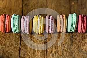 Cake macaron or macaroon on turquoise background from above, col