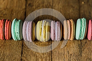 Cake macaron or macaroon on turquoise background from above, col