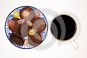 Cake makaroni on a plate with cup of coffee