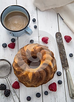 Cake. Marble cake cup of coffee powder sugar kitchen vintage utensil and fresh fruit berries