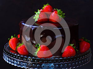 Dark chocolate ganache cake with strawberries photo