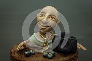 A cake with a model of a marcipan photographer