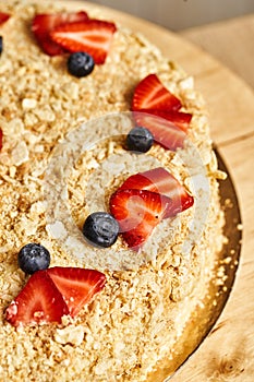 Cake napoleon. Board with delicious tasty homemade cake on table. Wooden background