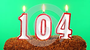 Cake with the number 104 lighted candle. Chroma key. Green Screen. Isolated