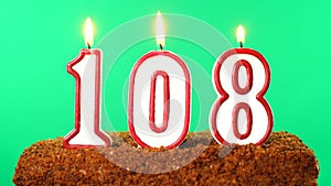 Cake with the number 108 lighted candle. Chroma key. Green Screen. Isolated