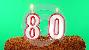 Cake with the number 80 lighted candle. Chroma key. Green Screen. Isolated