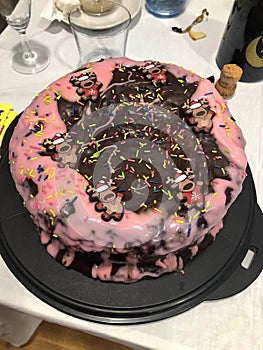 a cake with pink glaze and chocolate