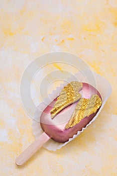 Cake pop with chocolate decorative golden wings