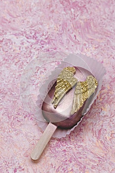 Cake pop with chocolate decorative golden wings