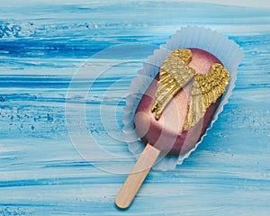 Cake pop with chocolate decorative golden wings