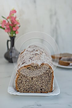 Cake with poppy seeds and lemon zest, sprinkled with powdered sugar