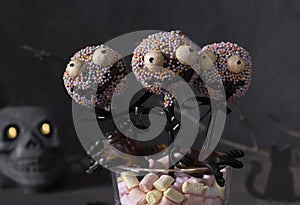 Cake pops as spooky monsters of dark chocolate for kids on Halloween party