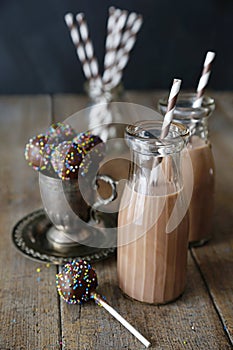 Cake pops and chocolate milk on table