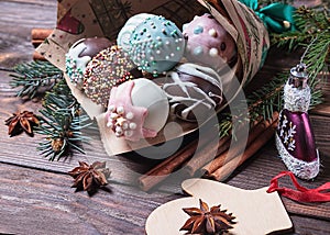 Cake pops. Sweet food. Dark wooden Christmas background. Christmas decorations.