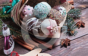 Cake pops. Sweet food. Dark wooden Christmas background. Christmas decorations.