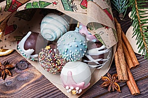 Cake pops. Sweet food. Dark wooden Christmas background. Christmas decorations.