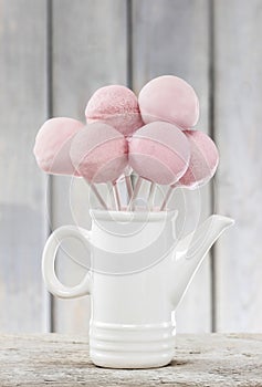 Cake pops on wooden table.