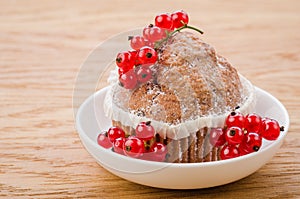 Cake with red currant berries on white plate/cake with red currant berries on white plate on a wooden background