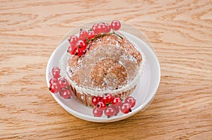 cake with red currant berries on white plate/cake with red currant berries on white plate on a wooden background. Top view