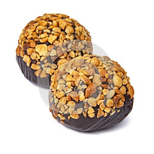 Cake rum truffle two balls with chopped nuts isolated on the white background