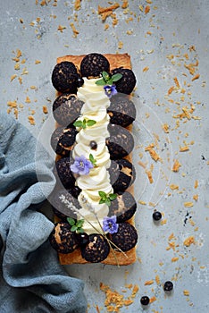 Cake of Saint-onore from puff pastry, profiteroles, currant cream and whipped cream. Classic French dessert. An exquisite confecti photo